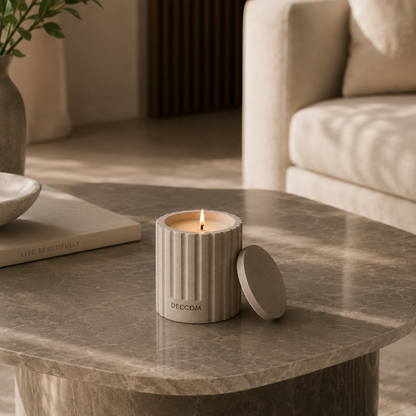 DECCOM Column Vessel soy candle styled on a marble coffee table in a warm minimalist interior
