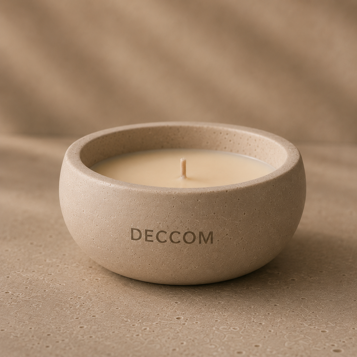 Close-up of DECCOM Quiet Bowl soy candle showing matte stone texture and natural soy wax
